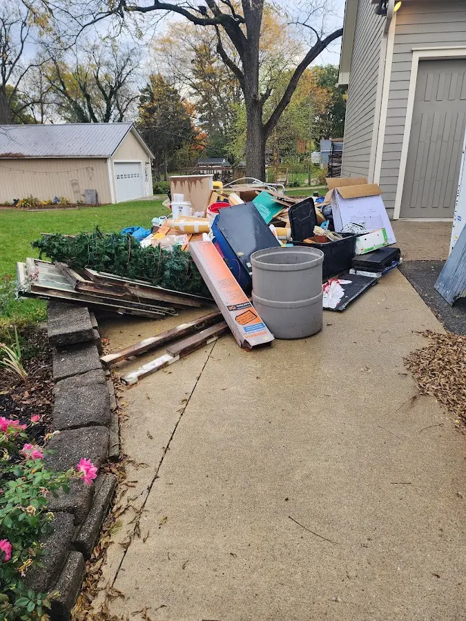 Dumpster being loaded with debris for 10 Yard Dumpster Rental in Gloucester Point